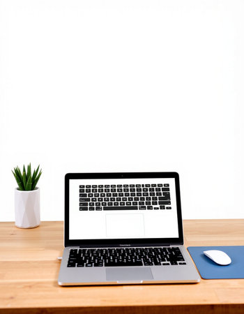 Laptop computer with blank screen on wood table and white wall backgroundの写真素材