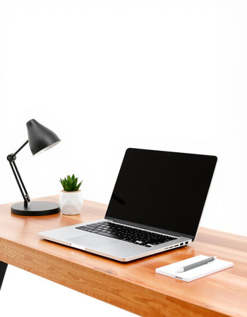 Laptop and office supplies on wooden table. Workplace background.