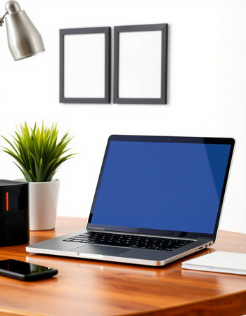 Laptop with blank screen on wooden desk in office. Workplace concept