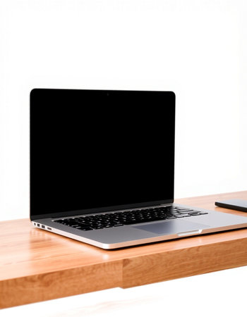 Laptop computer with blank screen on wooden desk isolated on white background