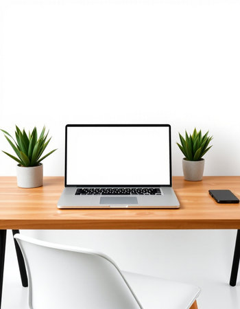 Modern workspace with blank screen laptop computer, smartphone and plant on wooden tableの写真素材