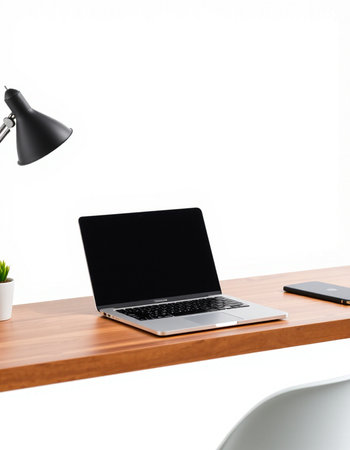 Laptop on wood desk and white wall background with clipping path.