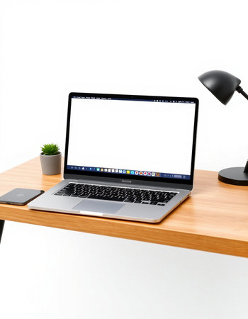 Laptop with blank screen on wooden desk isolated on white background.