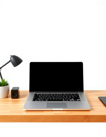 Laptop computer with blank screen on wooden desk isolated on white background