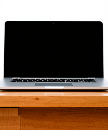 Laptop on a wooden table with a blank black screen on a white background