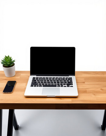 Laptop with blank screen on wooden table and white wall background.の写真素材