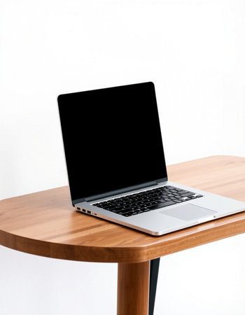 Laptop computer with blank screen on wooden table isolated on white backgroundの写真素材