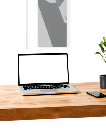 Close up of modern workplace with blank screen laptop computer, coffee cup and other items on wooden table. Mock upの写真素材