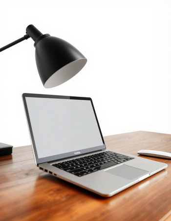 Laptop on a wooden table with a black lamp and a computer mouse