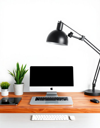 workplace with computer, lamp and plants on the white wall background