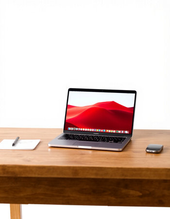 Laptop on a wooden table with a white background and a smartphone