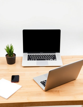 Laptop with blank screen on wooden desk in office, stock photoの写真素材