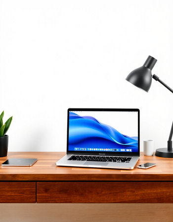 Workplace with modern laptop, lamp and other objects on wooden table