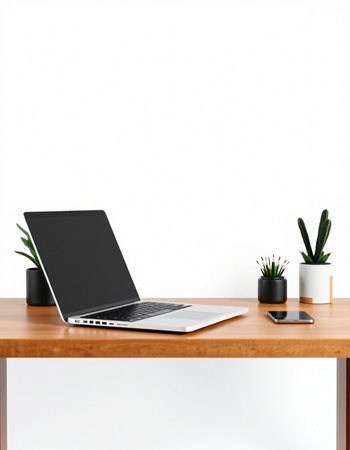 Laptop on a wooden table in front of a white wall.