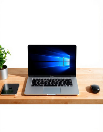 Laptop on a wooden table with a white background. View from above