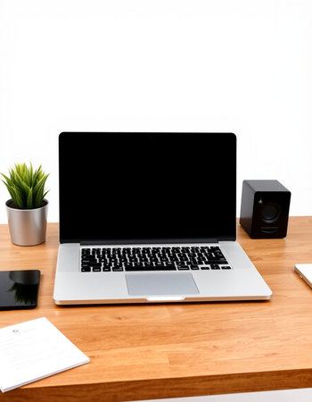 Laptop on wooden desk with copy space on white wall background.
