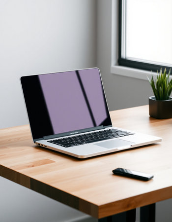 laptop with blank screen on wooden table in modern office. mock upの写真素材
