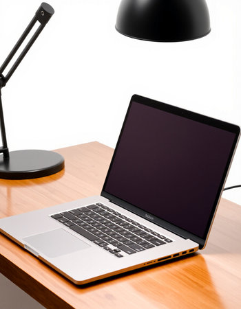 Laptop on a desk with a black lamp and a table lamp