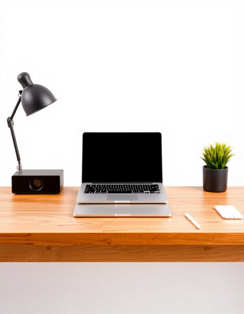 Laptop computer on wood desk with lamp and mouse on white background