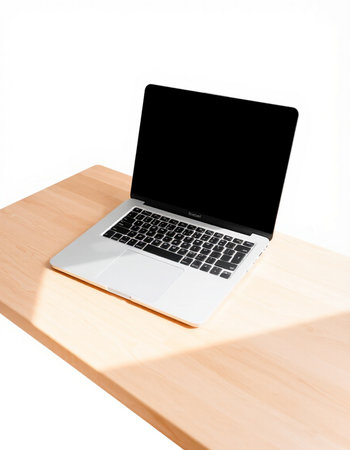 Laptop on wooden table isolated on white background with clipping path.
