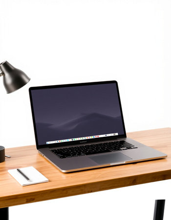 Laptop on wooden desk with white wall background and copy space.の写真素材