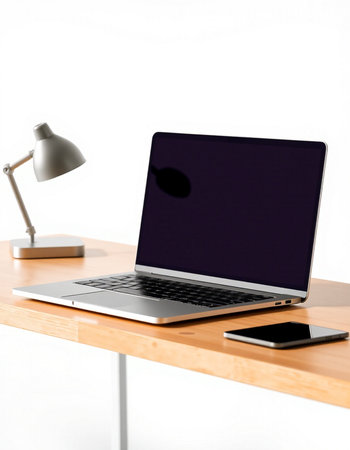 Laptop on a desk with a lamp on a white background.