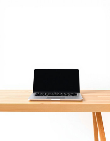 Laptop with blank screen on wood table isolated on white background.
