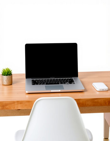 Laptop on wooden desk with white chair isolated on white background.