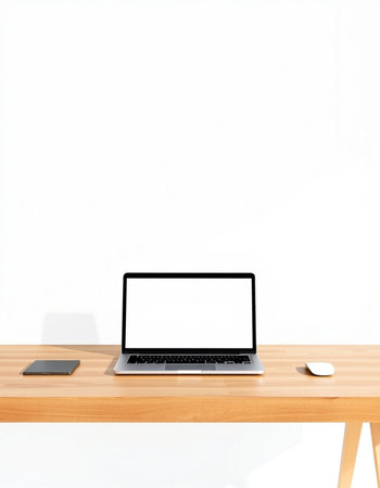 Laptop computer on wooden desk with white wall background, stock photo