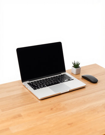 Laptop computer with blank screen on wooden desk isolated on white background