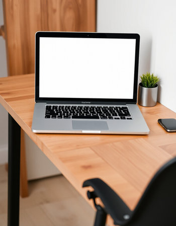 Laptop with blank screen on wooden desk in office. Mock up