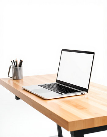 Laptop computer with blank screen on wooden table isolated on white backgroundの写真素材