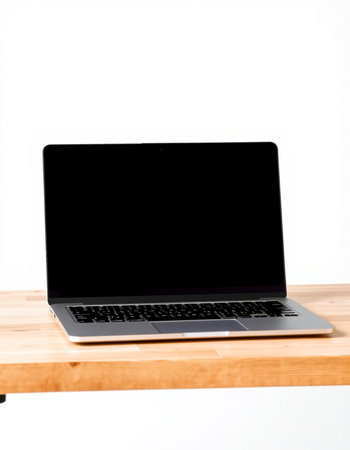 Laptop with blank screen on wooden table isolated on white background.の写真素材