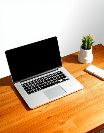 Laptop on wooden desk with white wall and copy space for your text