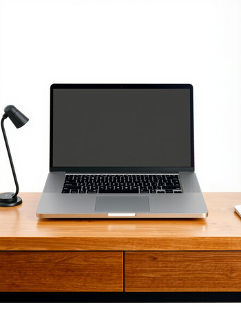Laptop on a wooden table with a lamp and a white background