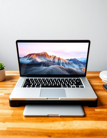 Laptop on wood table and white wall background with copy space.