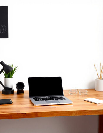 Modern workspace with blank screen laptop, coffee cup and other items on wooden table. Mock up