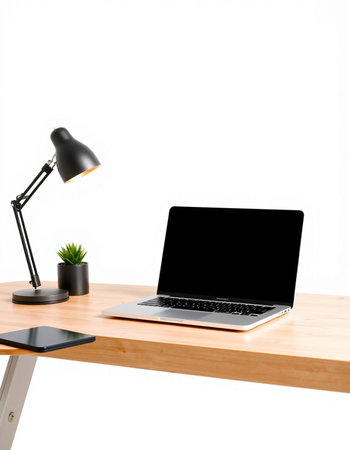 Laptop with blank screen on wooden table and lamp on white wall backgroundの写真素材