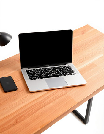 Laptop with blank screen on wooden desk isolated on white background.