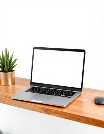 Laptop with blank screen on wooden table isolated on white background.
