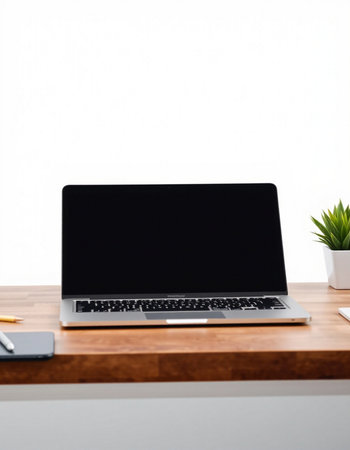 Laptop on wooden desk with copy space on white wall background.の写真素材