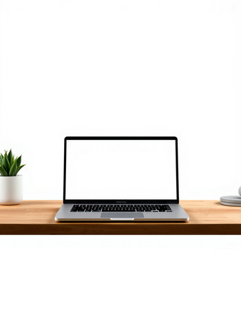 Laptop with blank screen on wood shelf and white wall background.