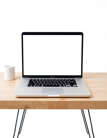 Laptop with blank screen on wooden desk isolated on white background.