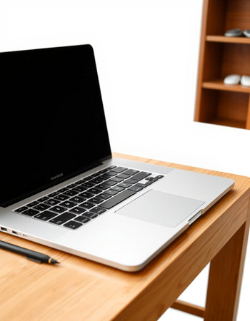Laptop on a wooden table with a bookcase in the background