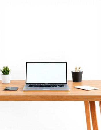 Laptop with blank screen on wooden table and white wall background.の写真素材