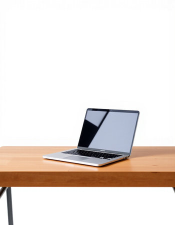 Laptop on wooden table isolated on white background with clipping path.の写真素材