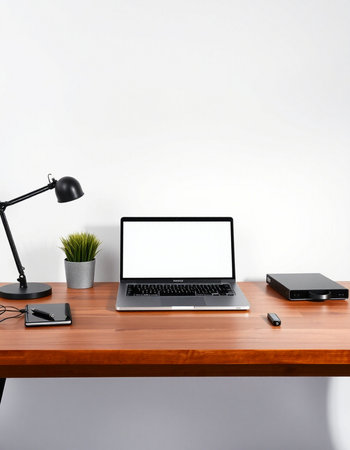 Laptop with blank screen on table in office. Mockup for designの写真素材