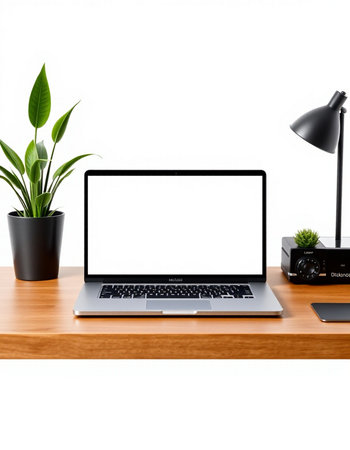workplace with blank screen laptop computer, lamp and plant isolated on white background