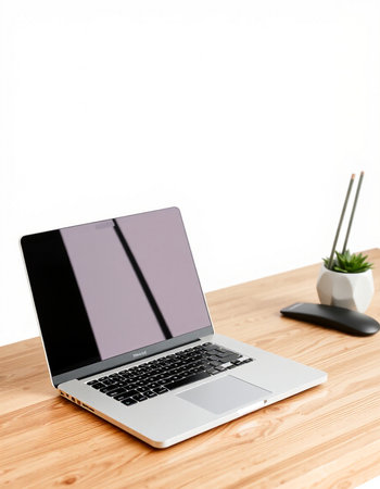 Laptop on wooden table with white background. Workplace concept.