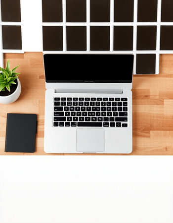 Top view of modern workplace with laptop, smartphone and coffee cup on wooden table.